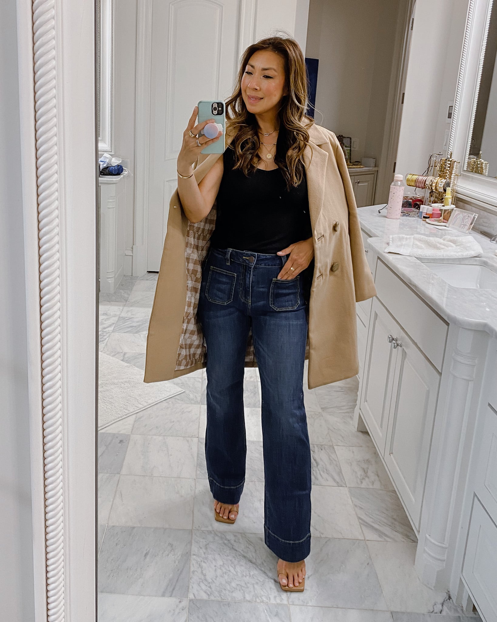 style of sam in busy tank, patch pocket jeans, and heritage coat
