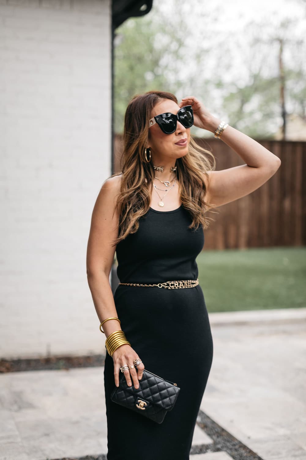Woman wearing stylish black dress and stylish accessories