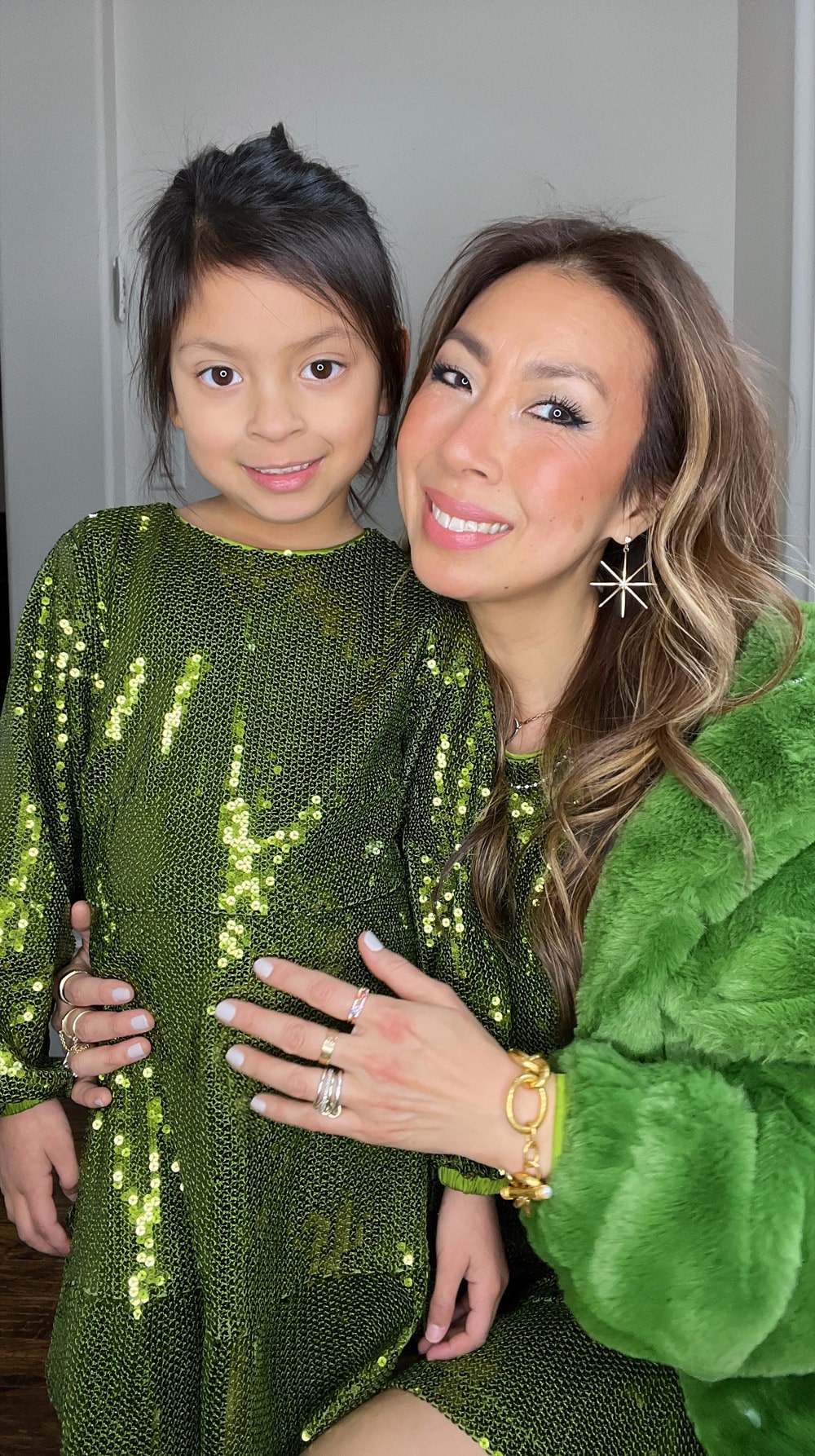 style of sam and daughter in green sequin dress and faux fur jacket