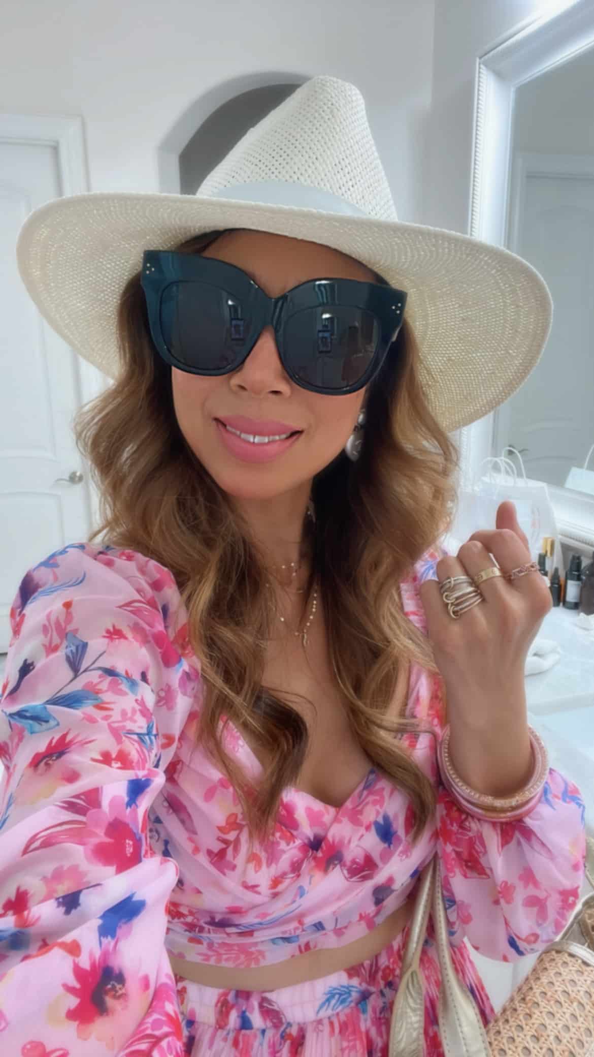 style of sam in allison new york pink floral crop top and skirt set, janessa leone packable hat, linda farrow oversized sunglasses