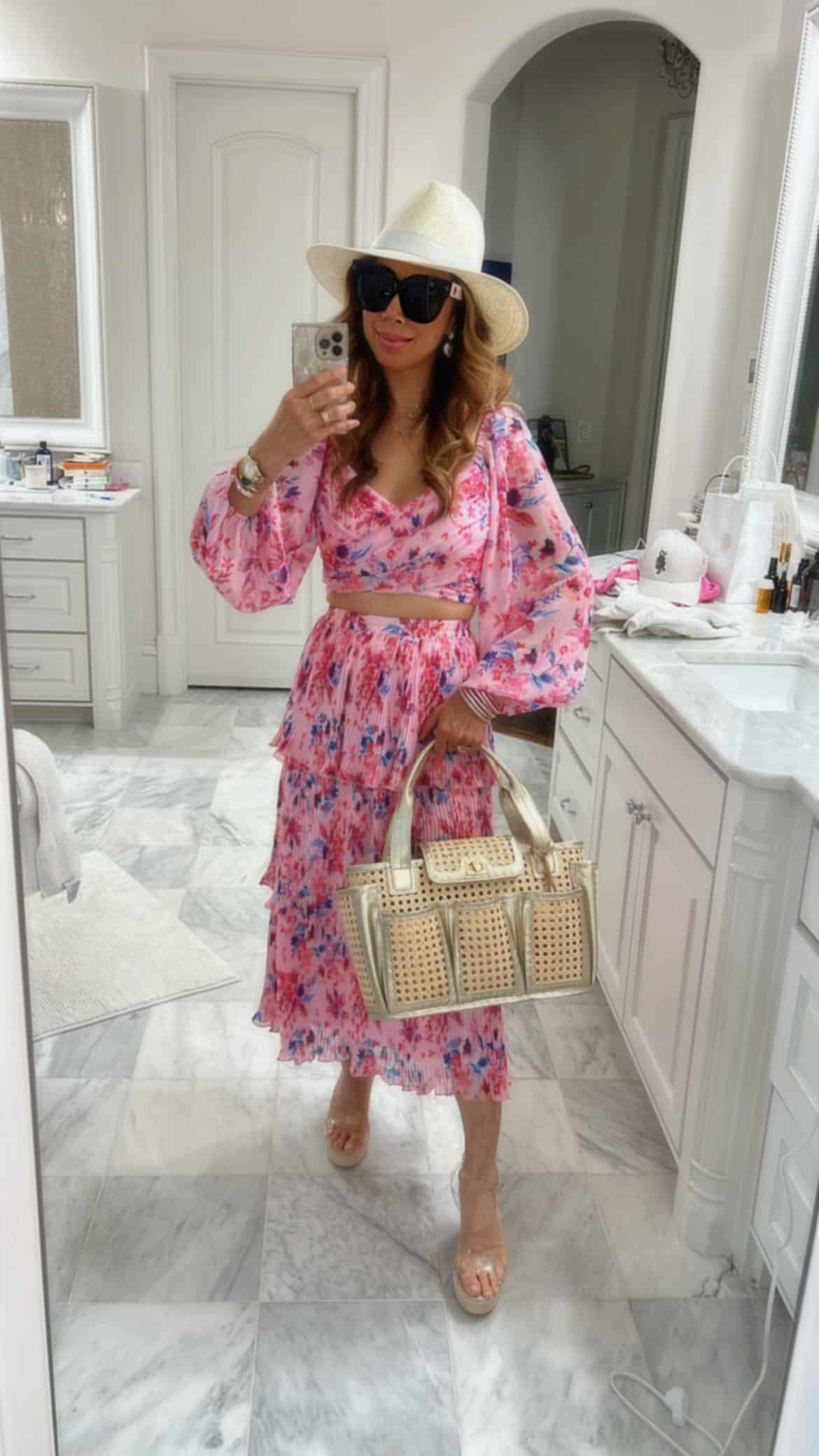 style of sam in allison new york pink floral crop top and skirt set, janessa leone packable hat, linda farrow oversized sunglasses