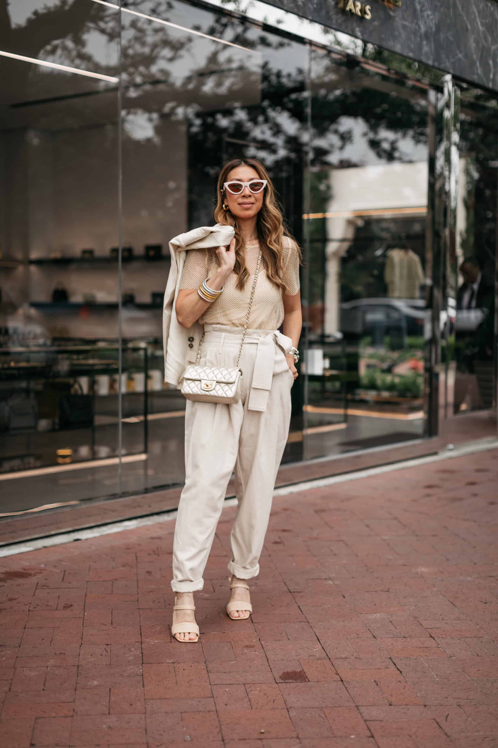 Dallas blogger wearing mesh top and beige pants and blazer